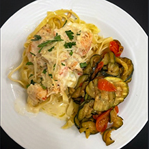 A dish of chef-prepared chicken spaghetti and vegetables, made with fresh ingredients, at The Summit Senior Living at Chenal Valley.